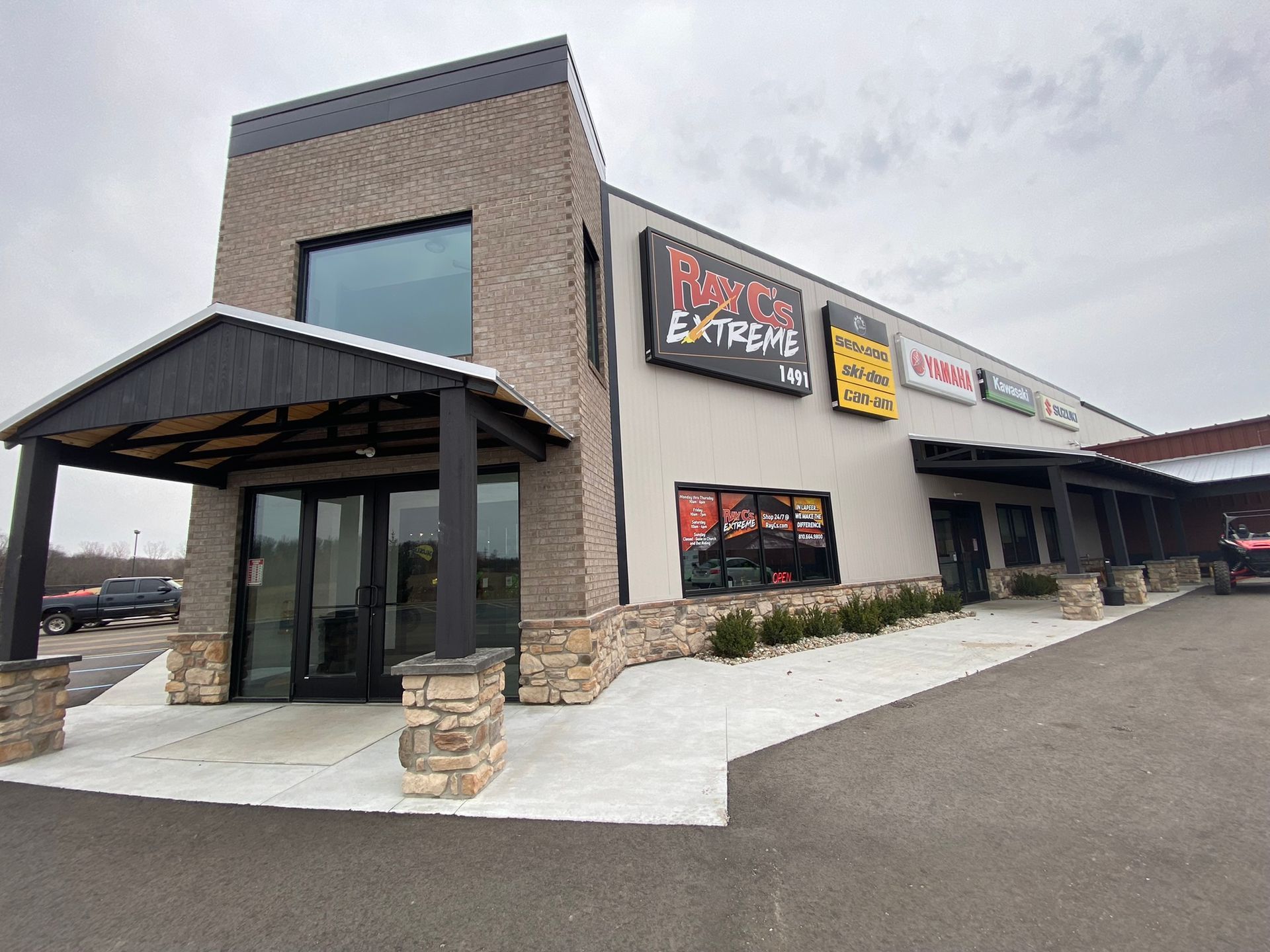 A large building with a lot of windows and signs on it.