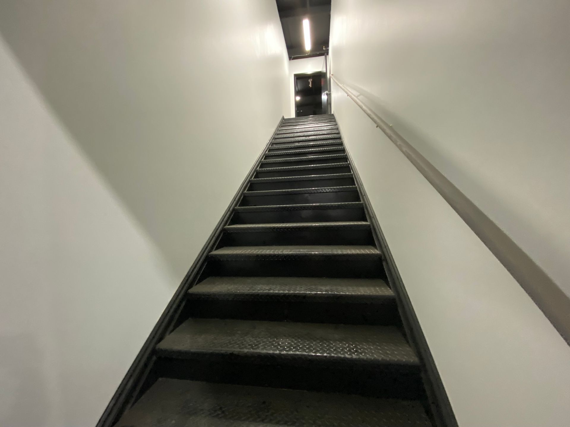 A set of stairs going up a white wall