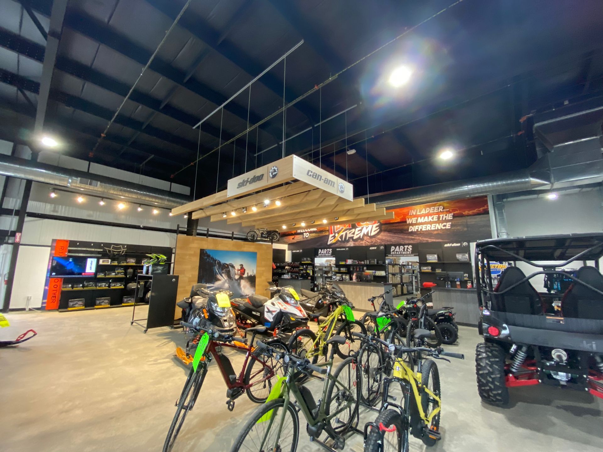 A row of bicycles are lined up in a showroom.