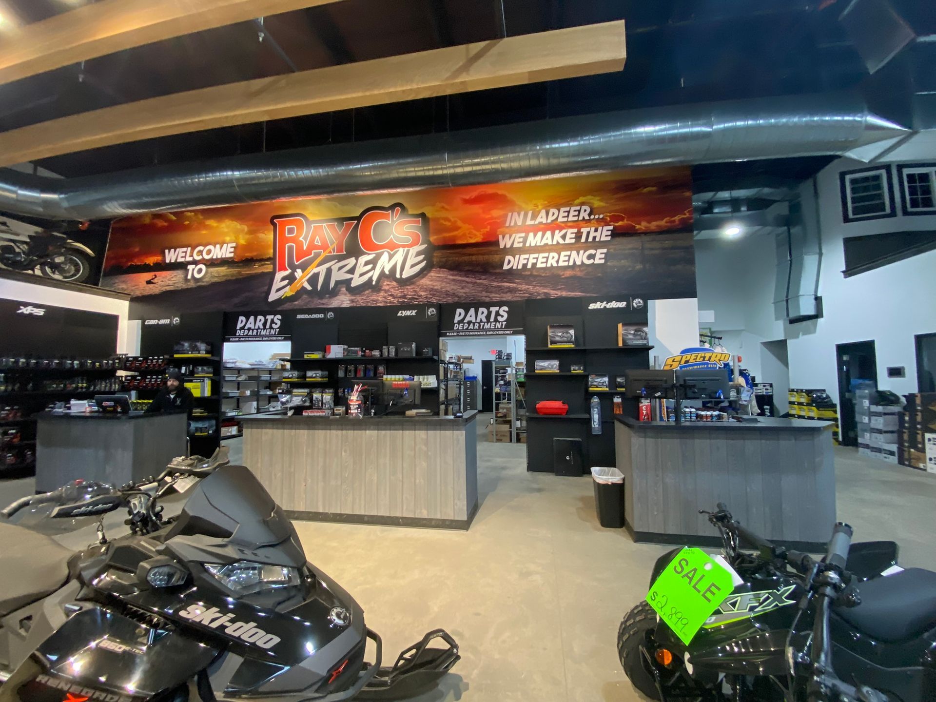 A store filled with lots of motorcycles and snowmobiles.