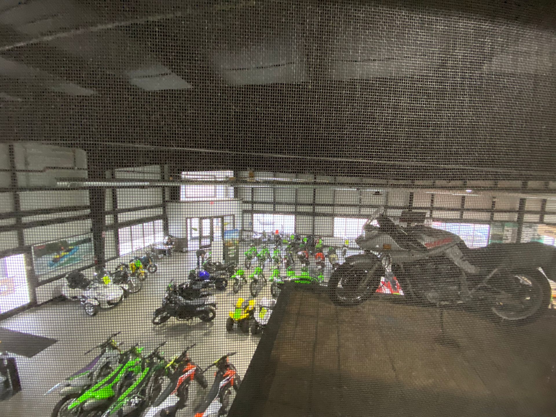 A motorcycle is sitting on top of a ramp in a showroom.