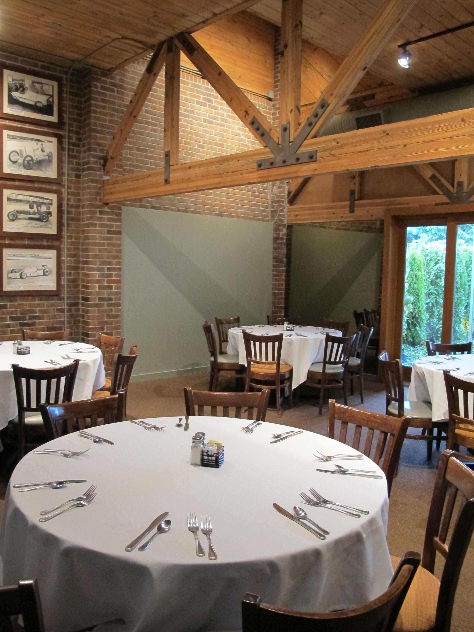 A dining room with tables and chairs and pictures on the wall