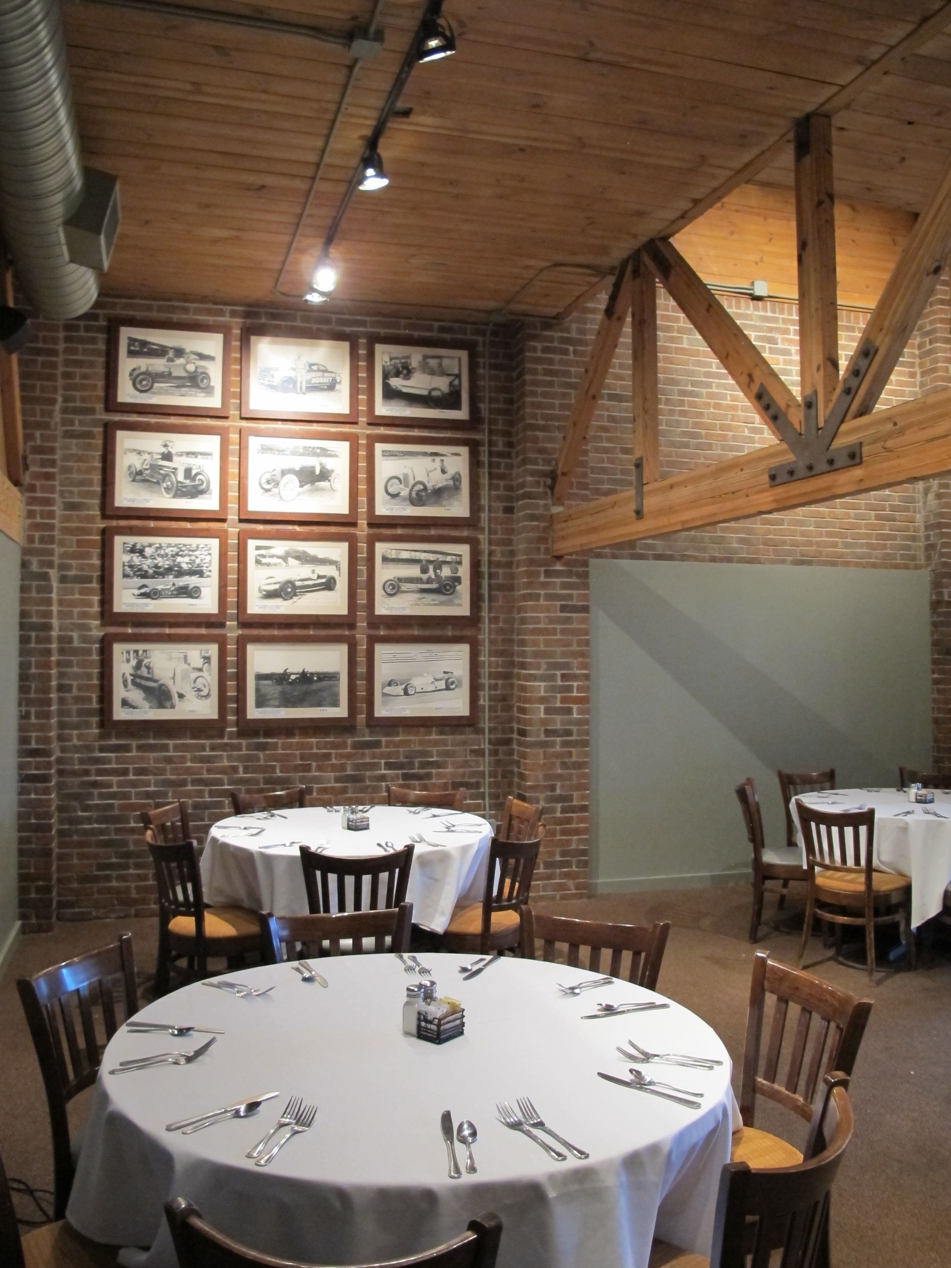 A dining room with tables and chairs and pictures on the wall