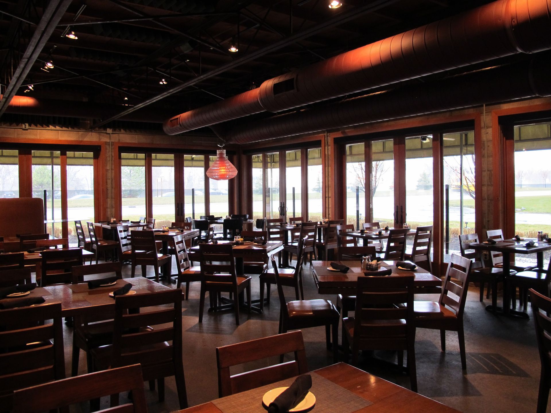 A restaurant with tables and chairs and lots of windows
