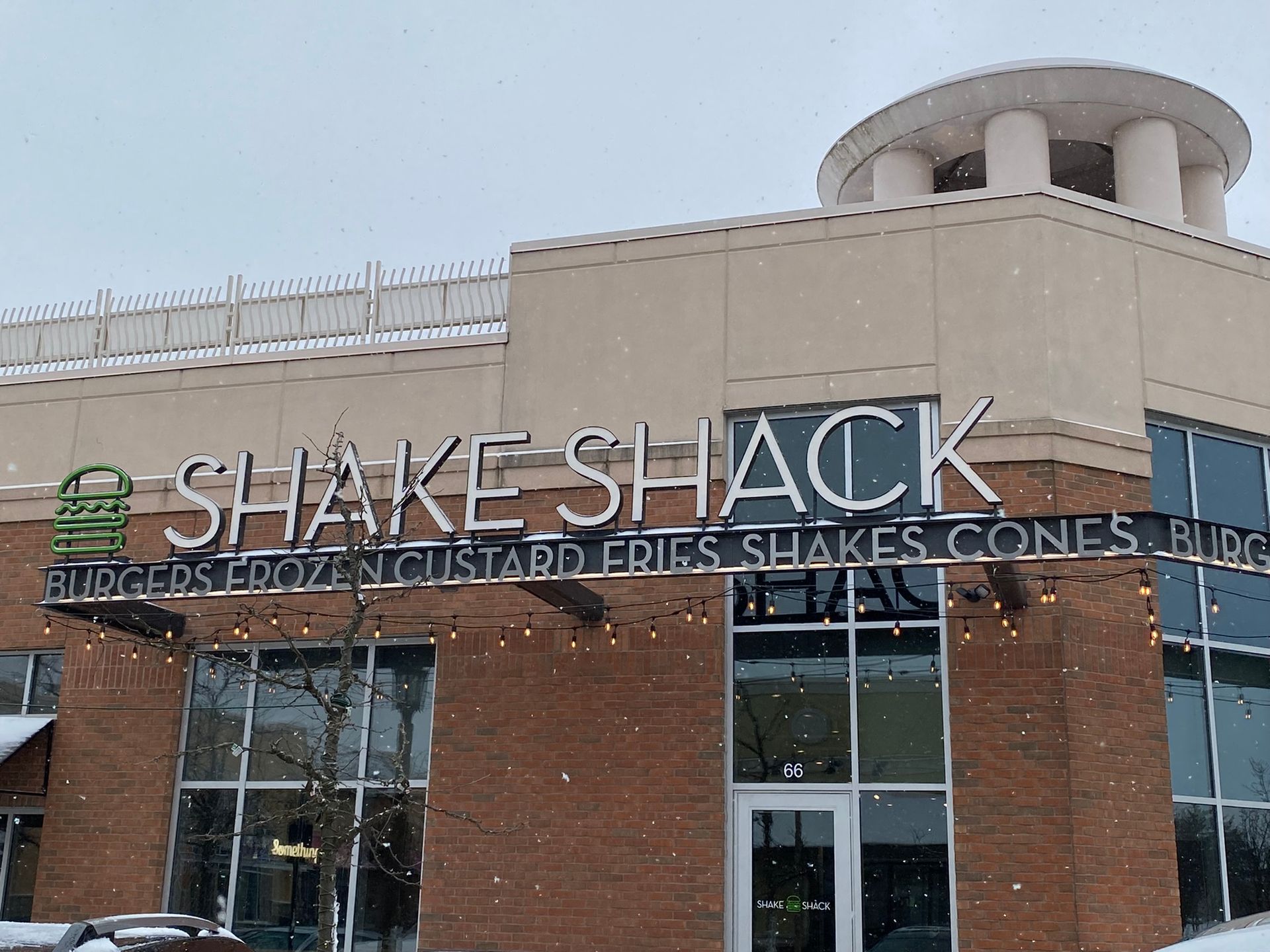 The outside of a shake shack restaurant in the snow