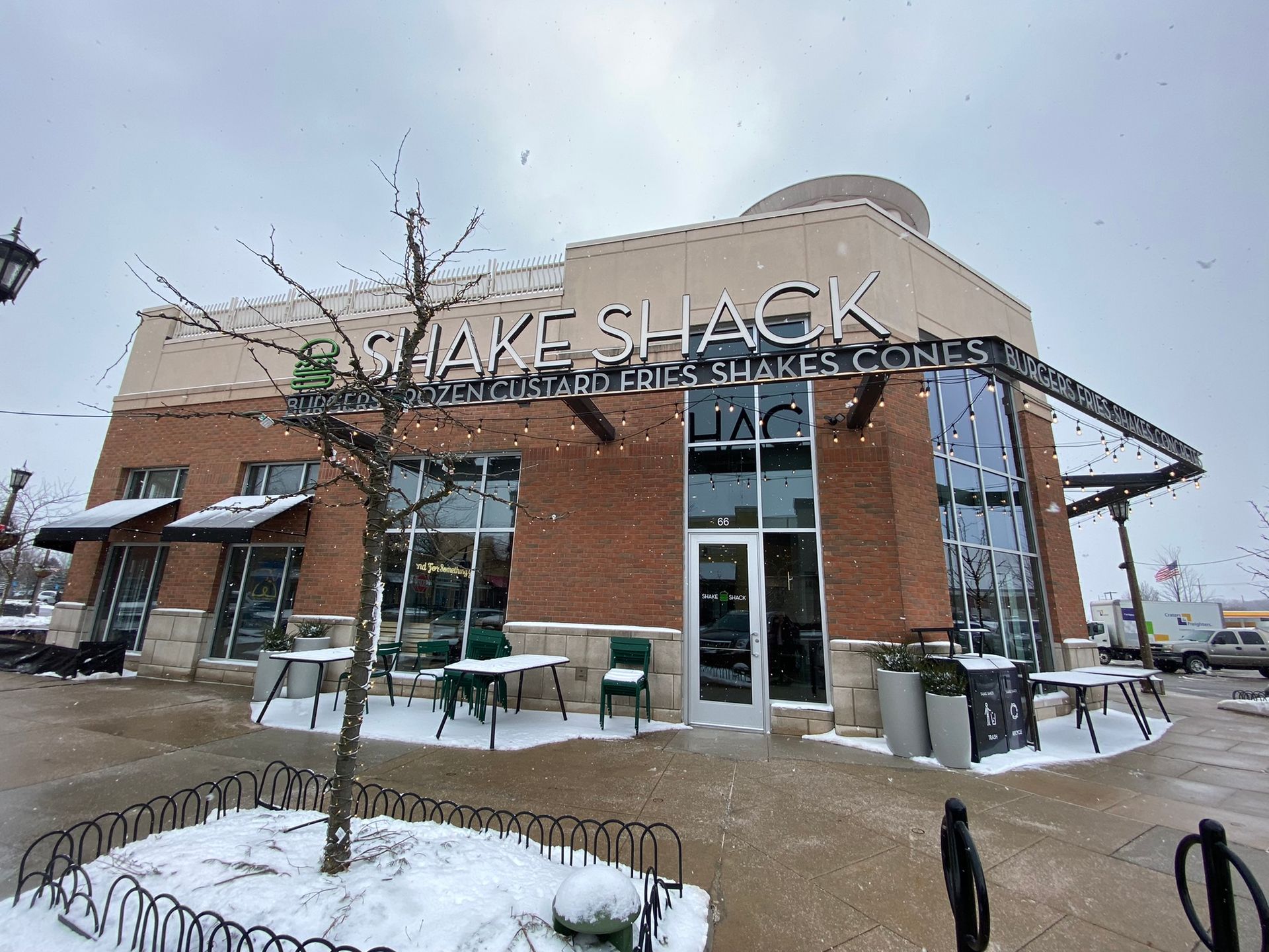 A brick building with a sign that says shake shack on it
