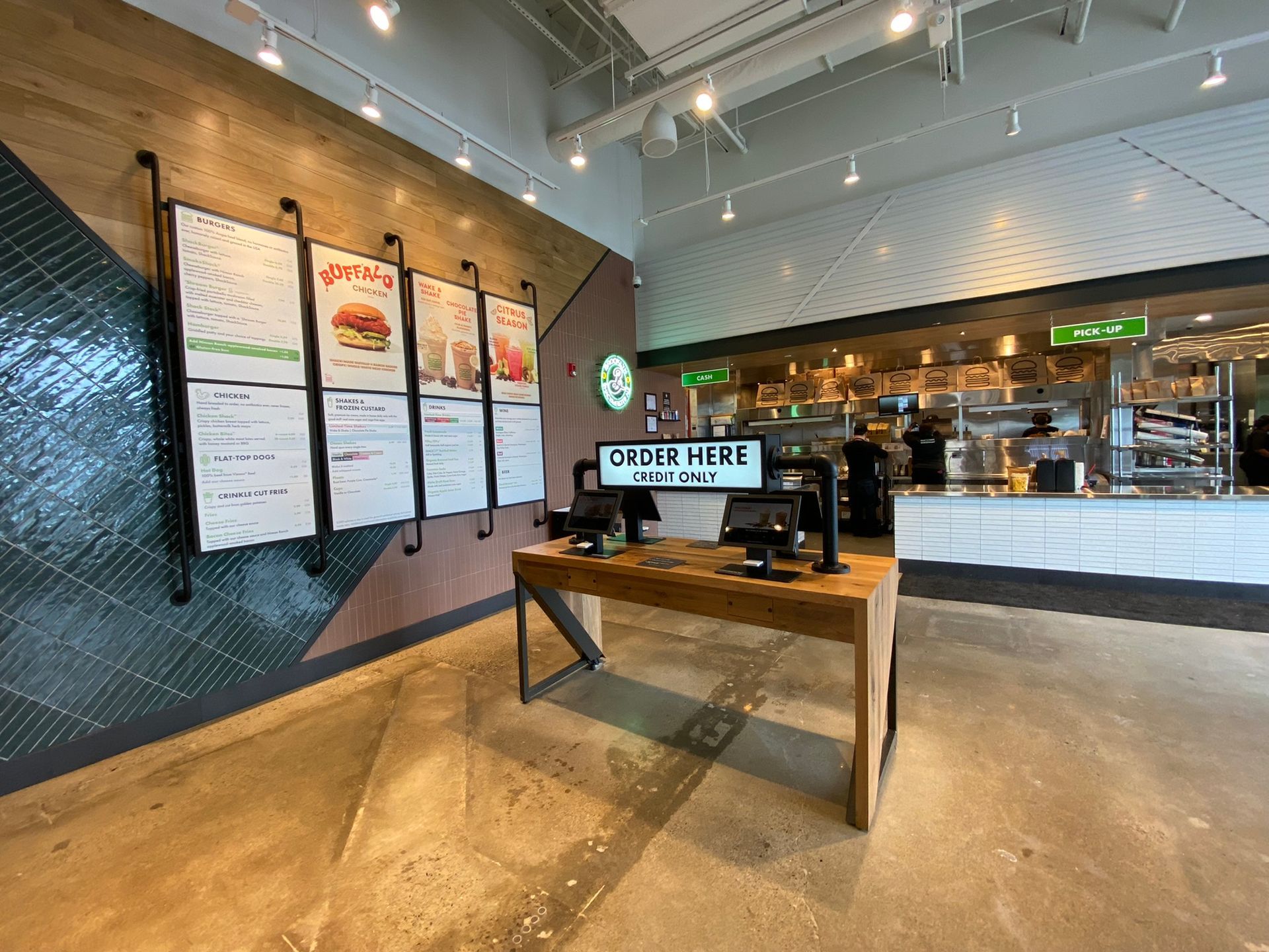 A restaurant with a wooden table and a computer on it.