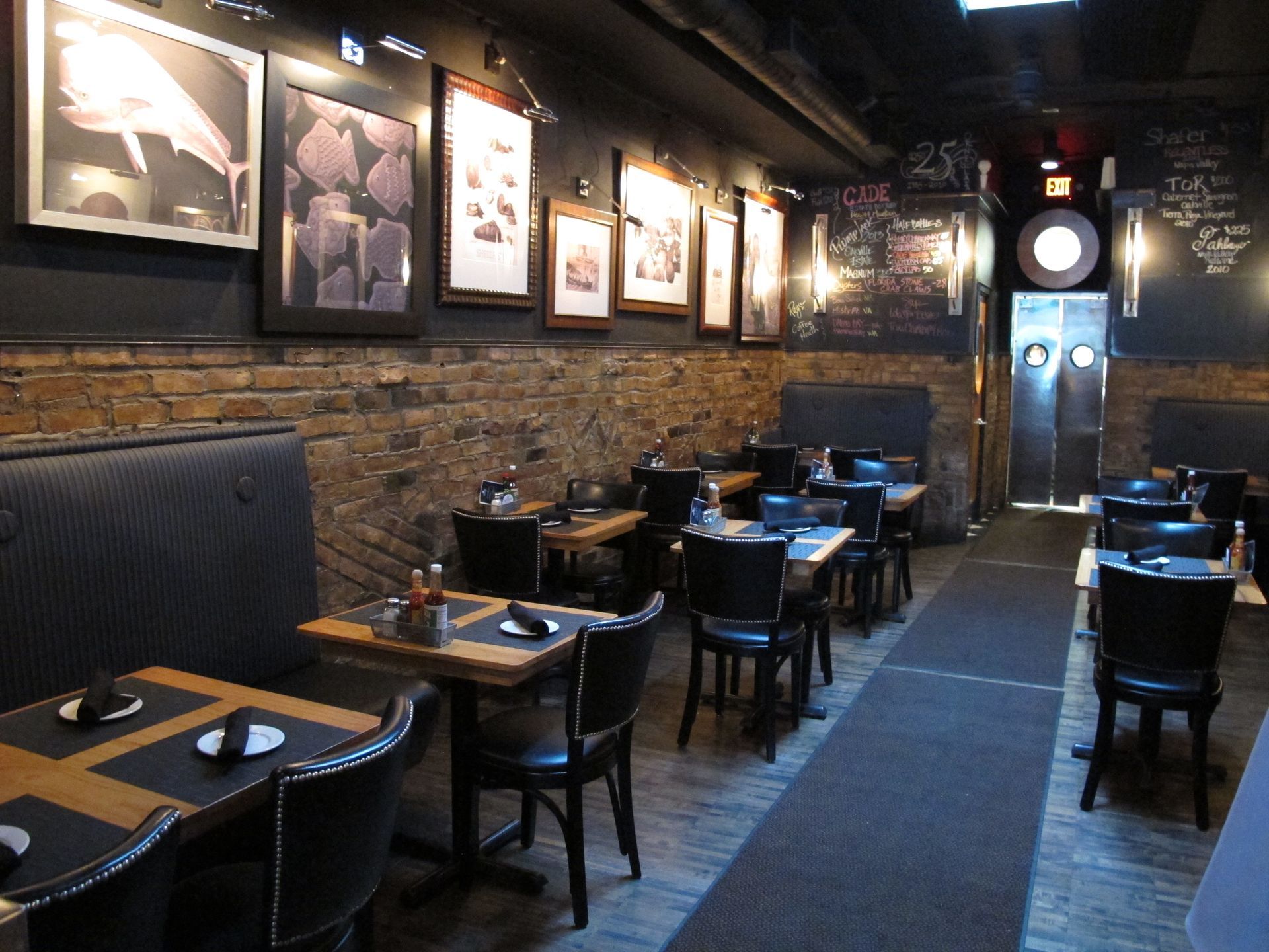 A restaurant with tables and chairs and pictures on the wall