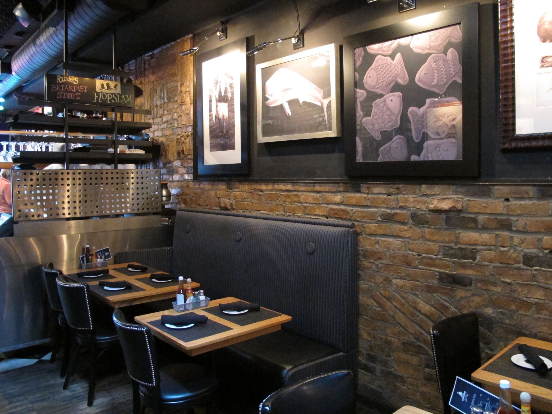 A restaurant with tables and chairs and pictures on the wall