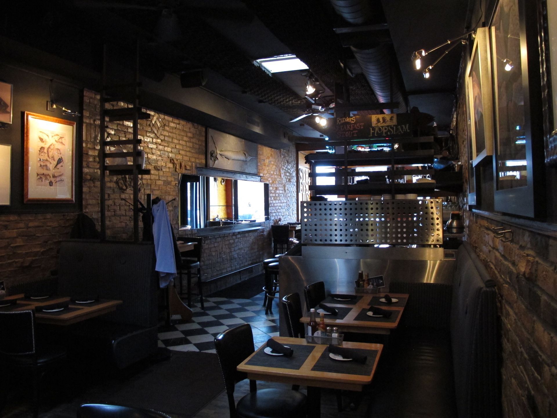 A restaurant with tables and chairs and a checkered floor