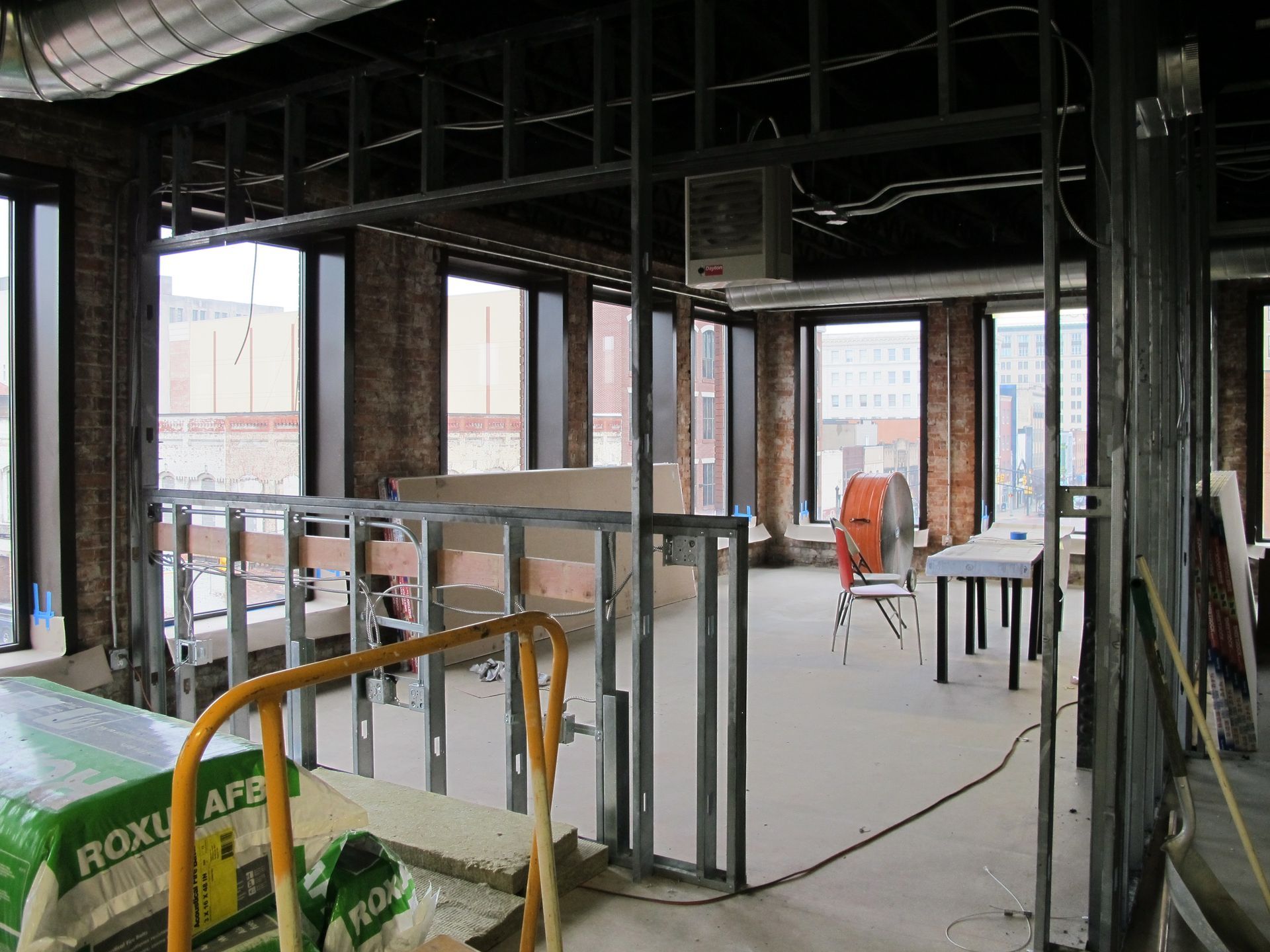 A building under construction with a box of roxtape on the floor