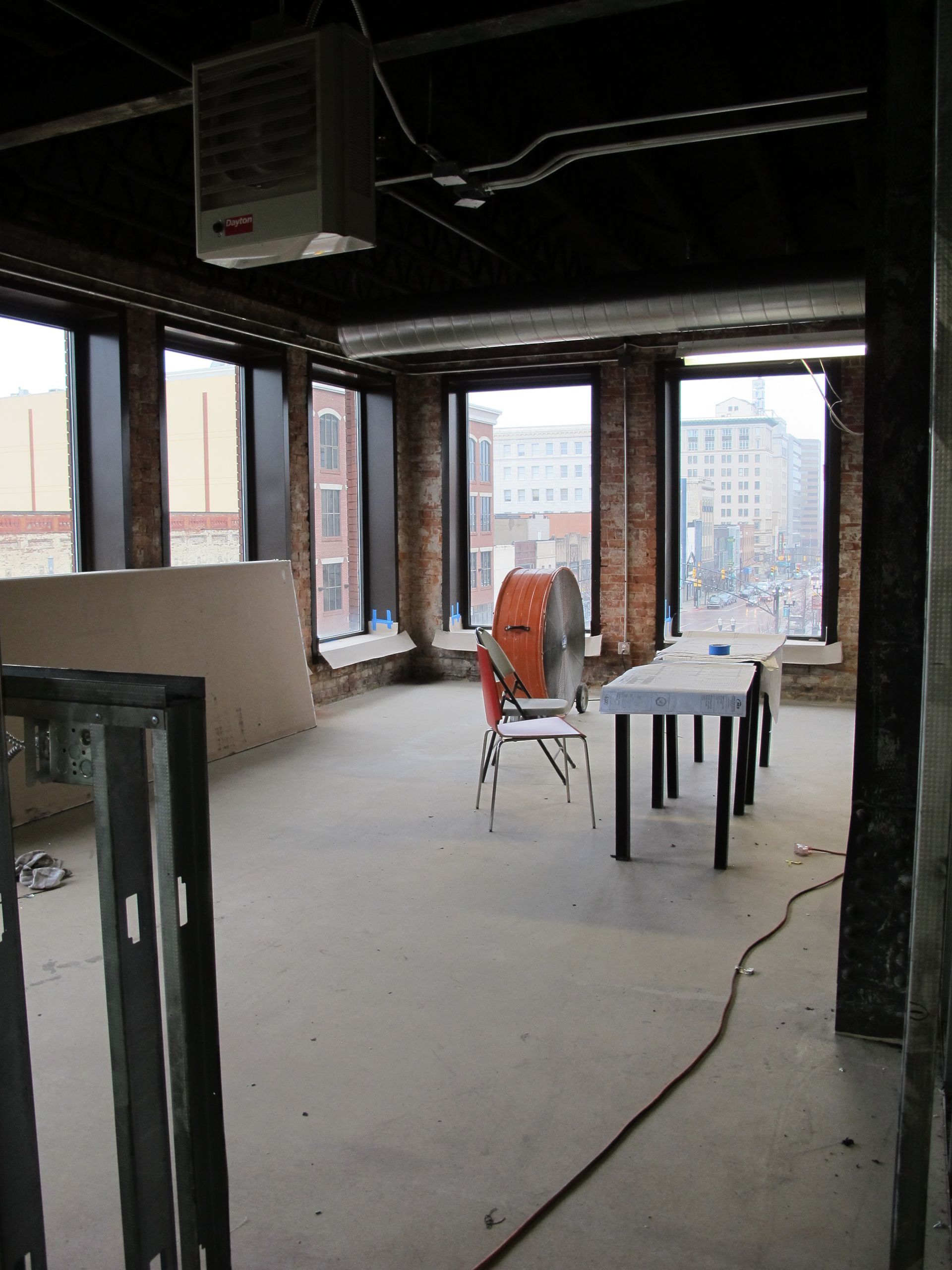 An empty room with a table and chairs in it