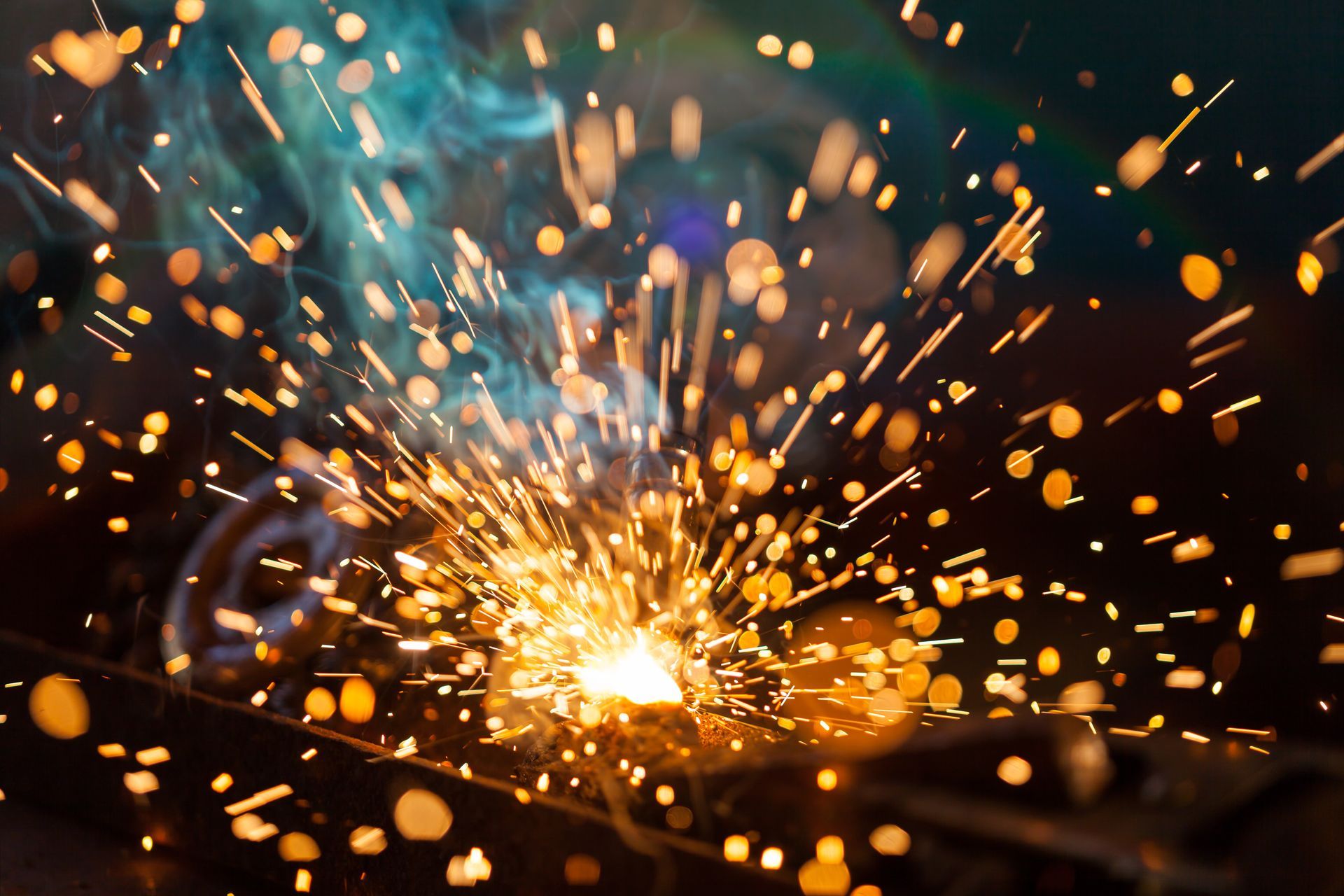 Bright welding sparks and smoke bursting from metal in a dark workshop setting Bright welding sparks and smoke bursting from metal in a dark workshop setting