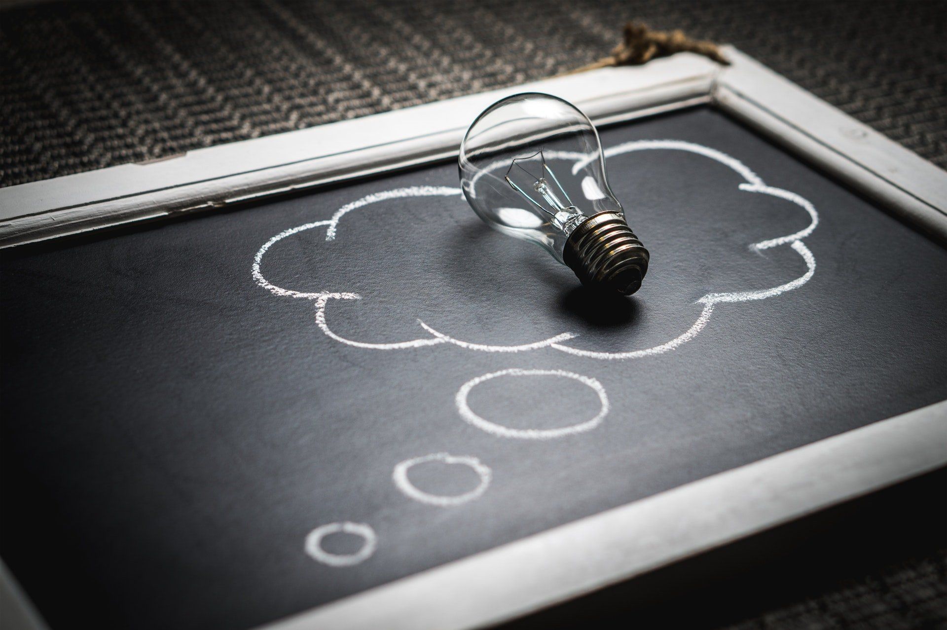 photograph showing light bulb sitting on chalkboard with bubble gif