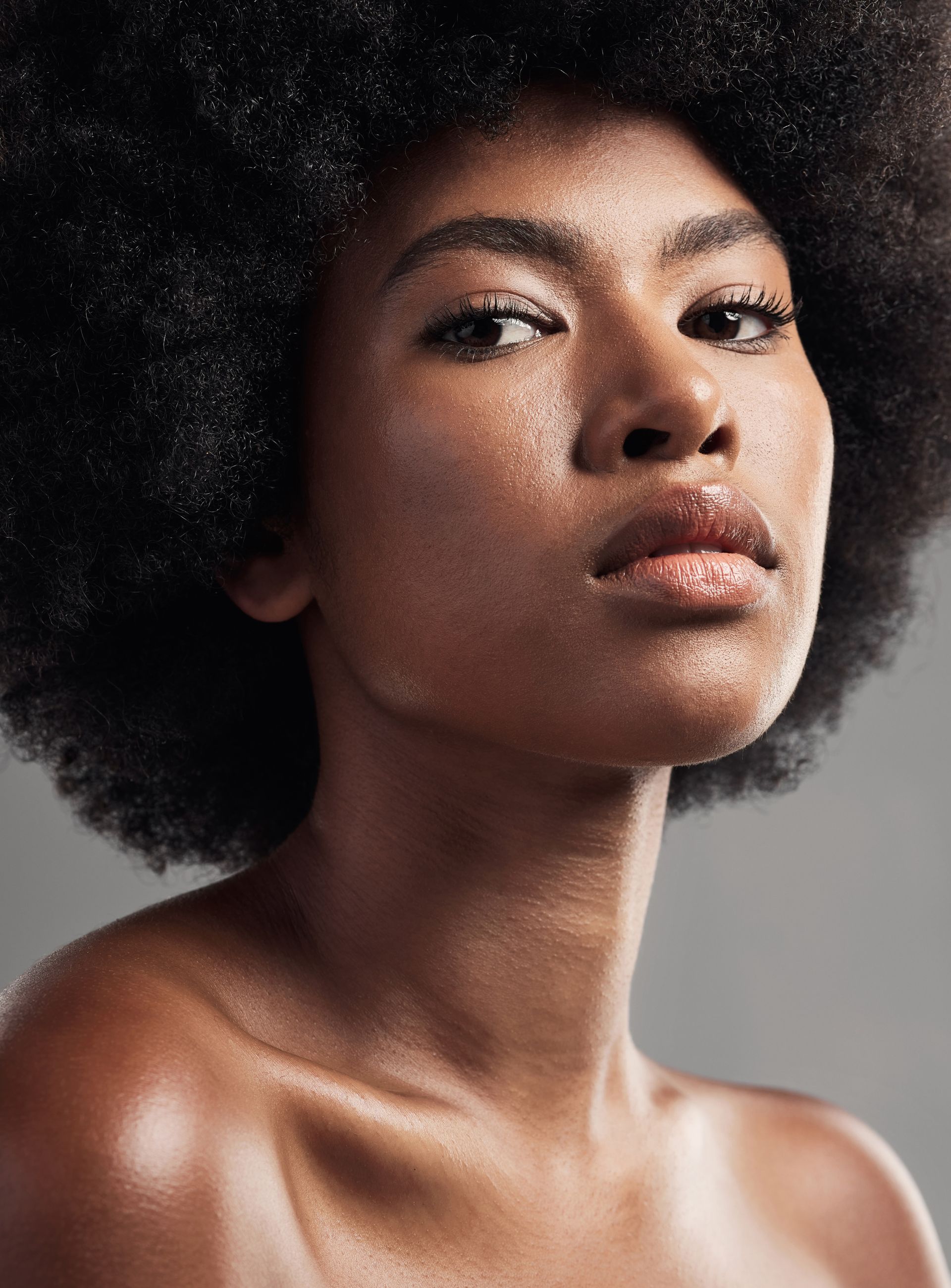 A close up of a woman 's face with her eyes closed.