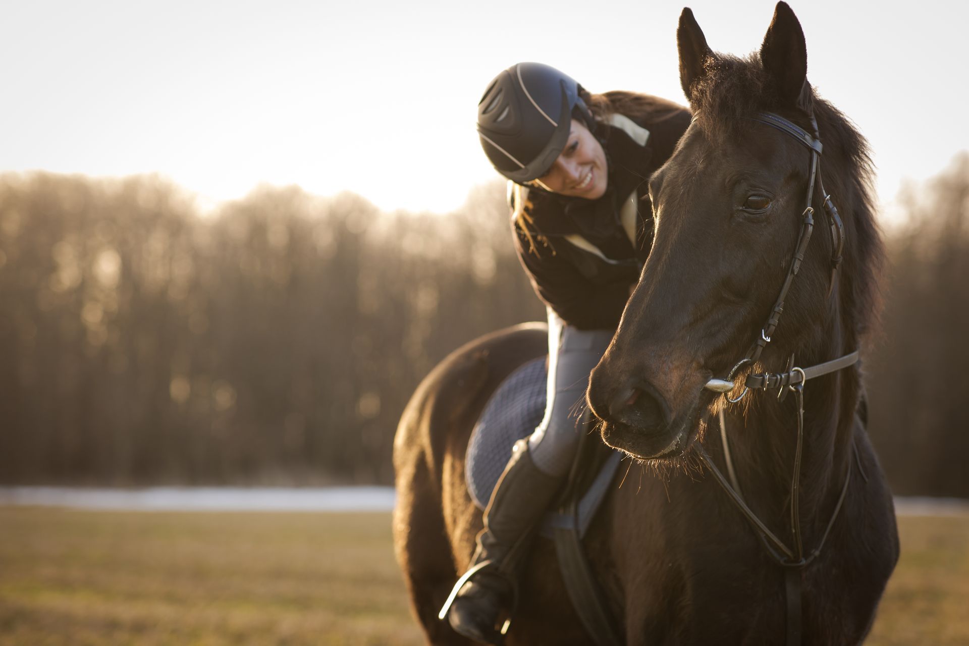 A woman is riding a horse in a field.