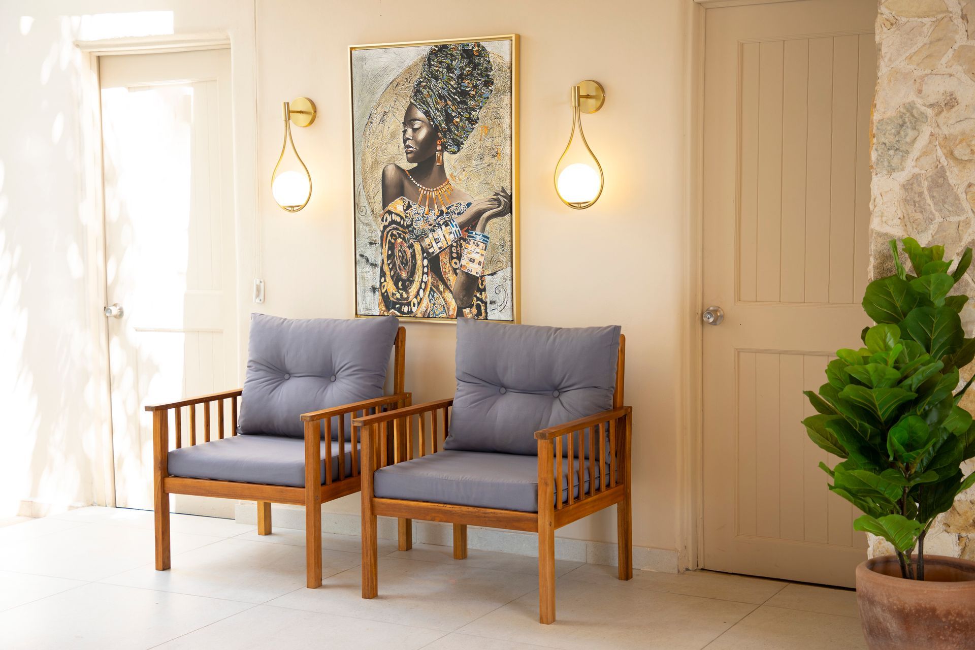 Dos sillas están una al lado de la otra en una habitación con una pintura en la pared.