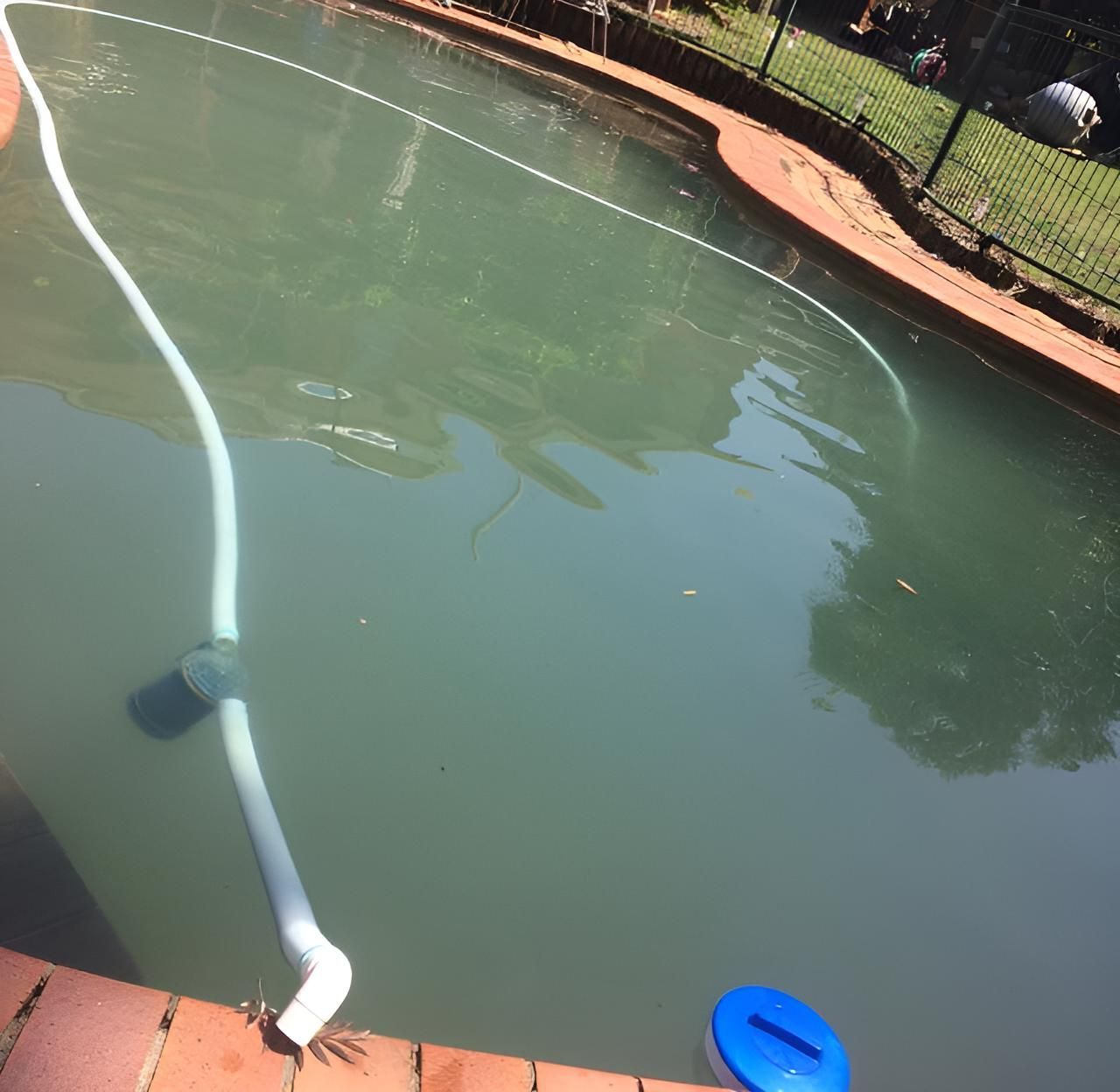 A Swimming Pool With A Hose Attached To It — Aqua Duck Pool Care In Landsborough, QLD