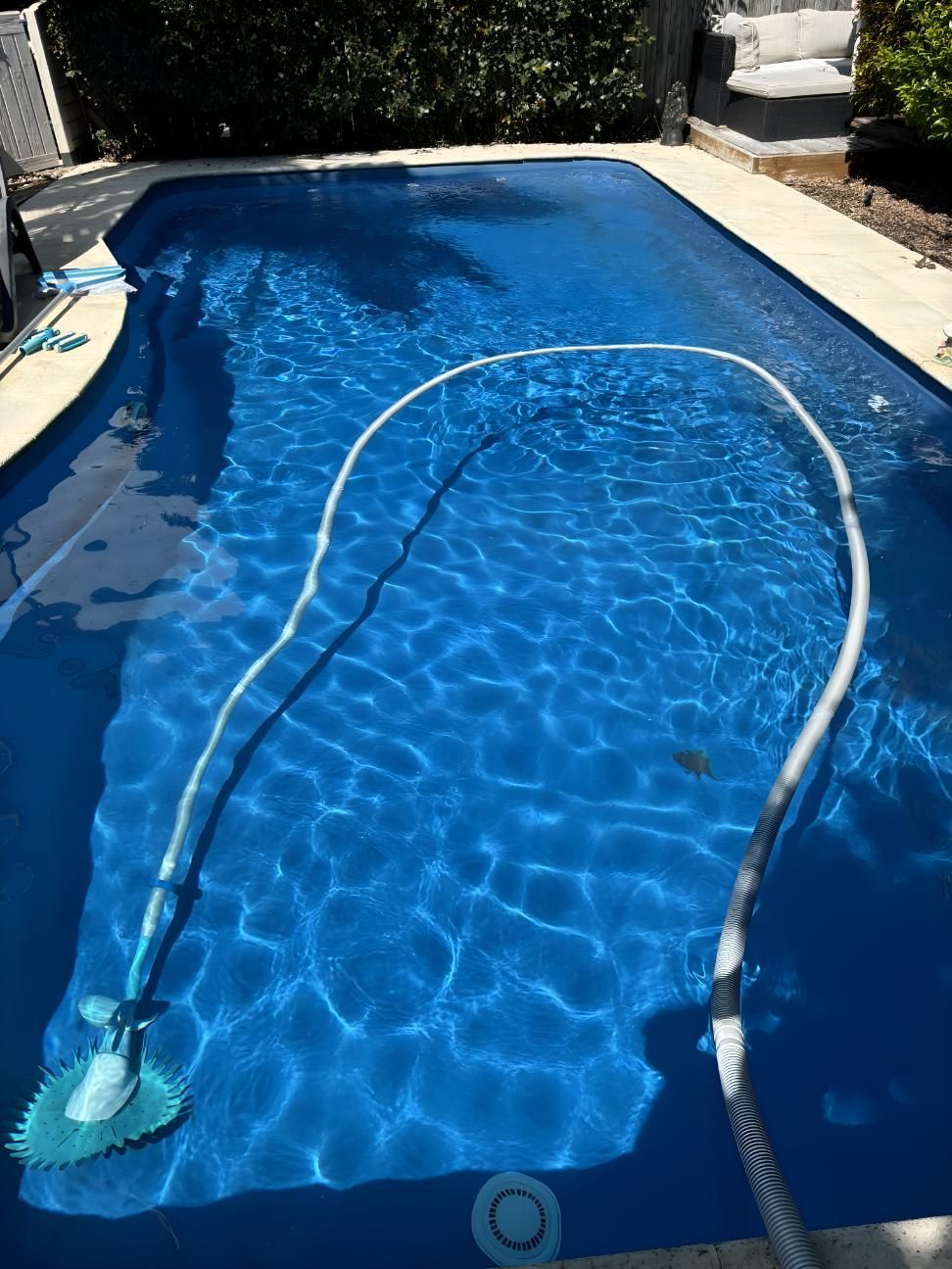 A Large Swimming Pool With A Hose Attached To It — Aqua Duck Pool Care In Landsborough, QLD