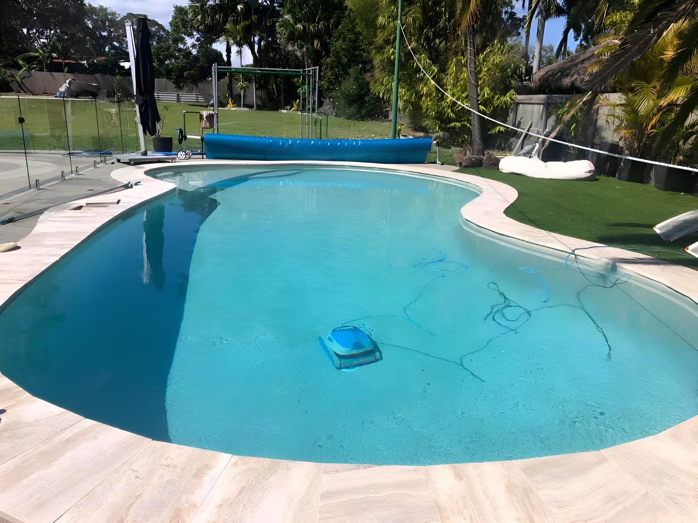 A Large Swimming Pool With A Robotic Cleaner In The Water — Aqua Duck Pool Care In Landsborough, QLD