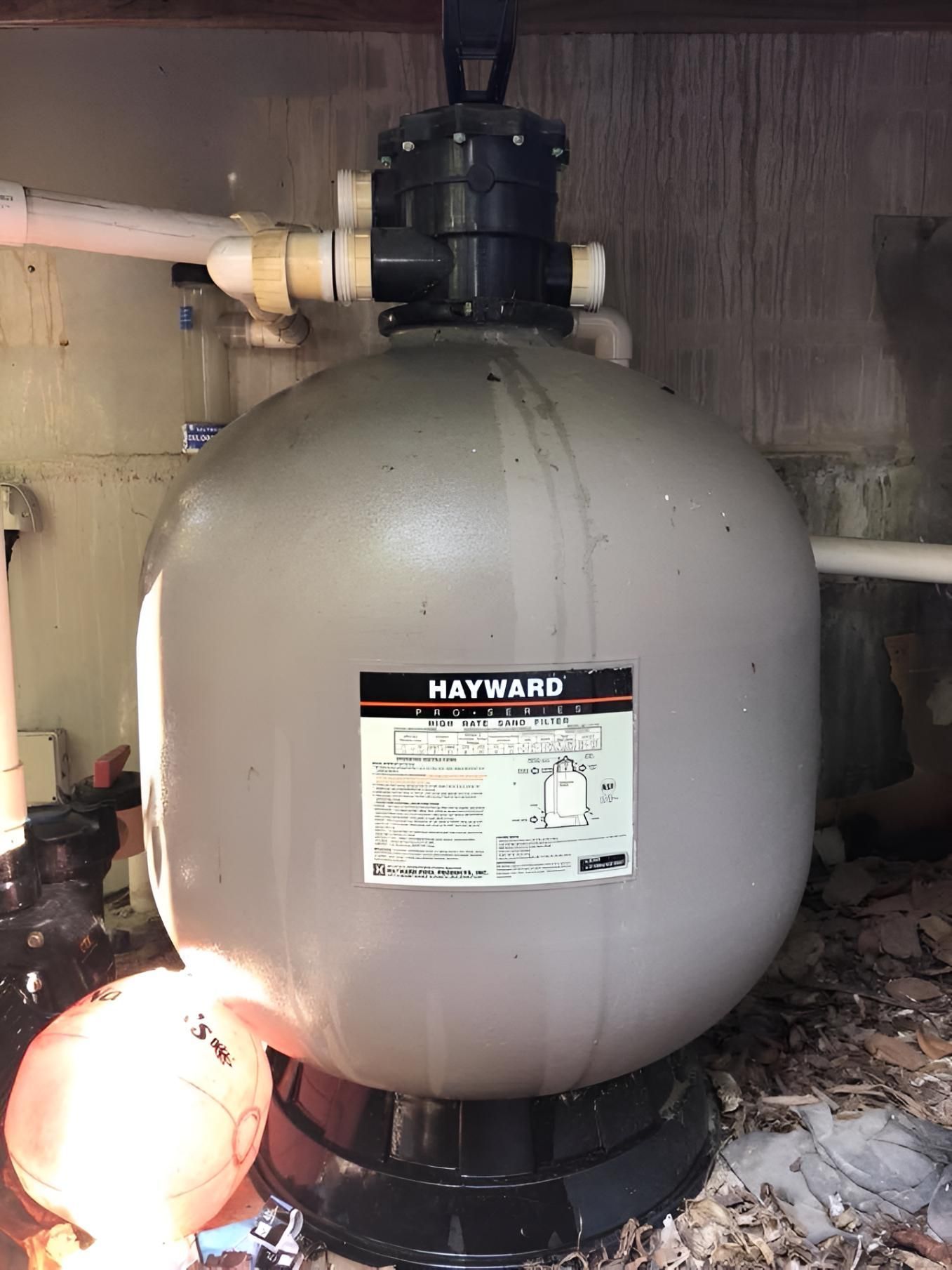 A Hayward Sand Filter Is Sitting On Top Of A Wooden Floor — Aqua Duck Pool Care In Landsborough, QLD