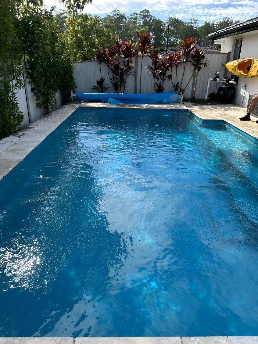 A Large Swimming Pool With A Yellow Kayak In It — Aqua Duck Pool Care In Landsborough, QLD