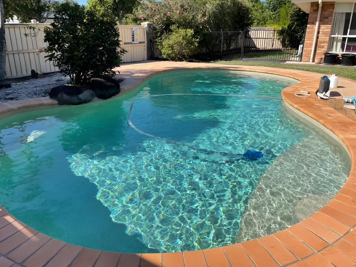 A Large Swimming Pool In The Backyard Of A House — Aqua Duck Pool Care In Landsborough, QLD