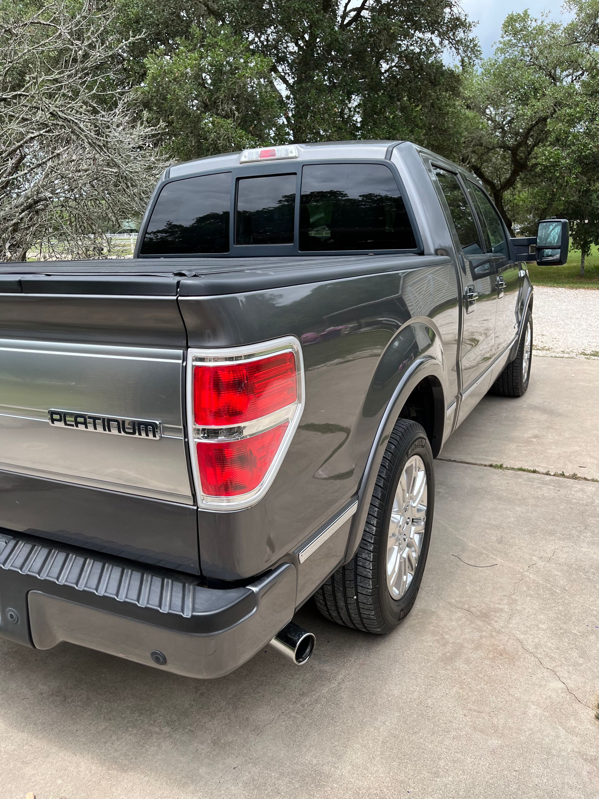 Gray Ford F-150 Platinum pickup truck parked outside.