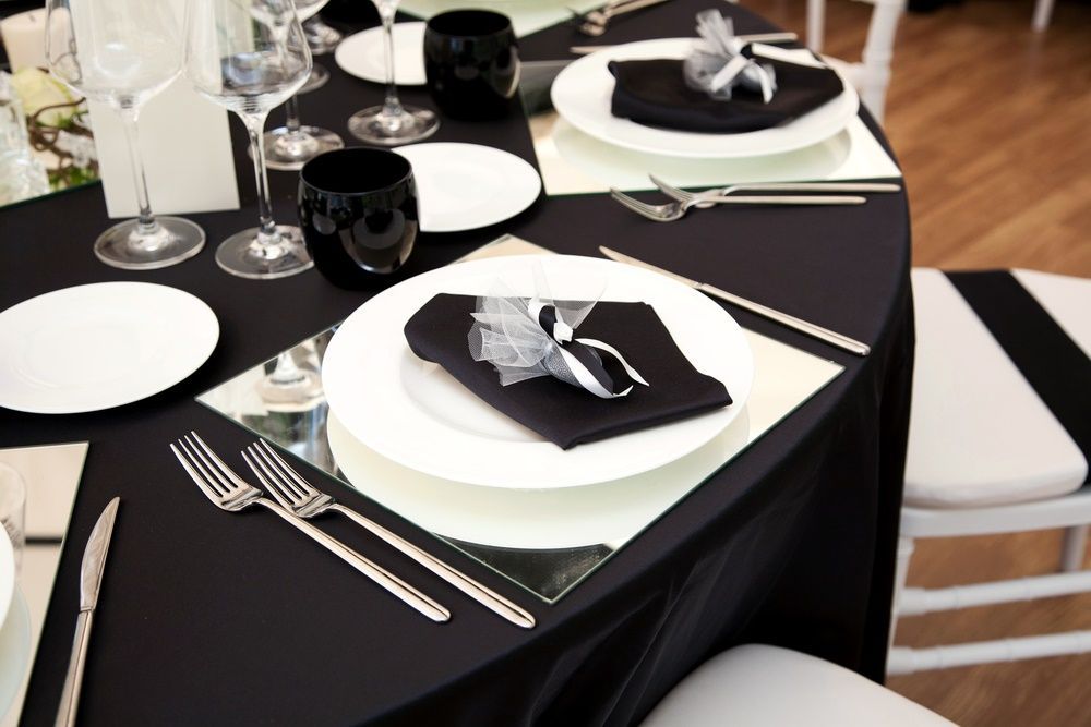 A Table Set With Black And White Plates And Silverware — Grafton Hire In South Grafton, NSW