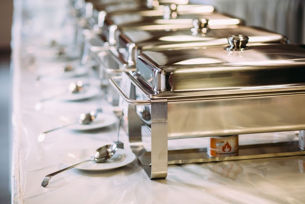 A Row Of Stainless Steel Buffet Trays On A Table. — Grafton Hire In South Grafton, NSW