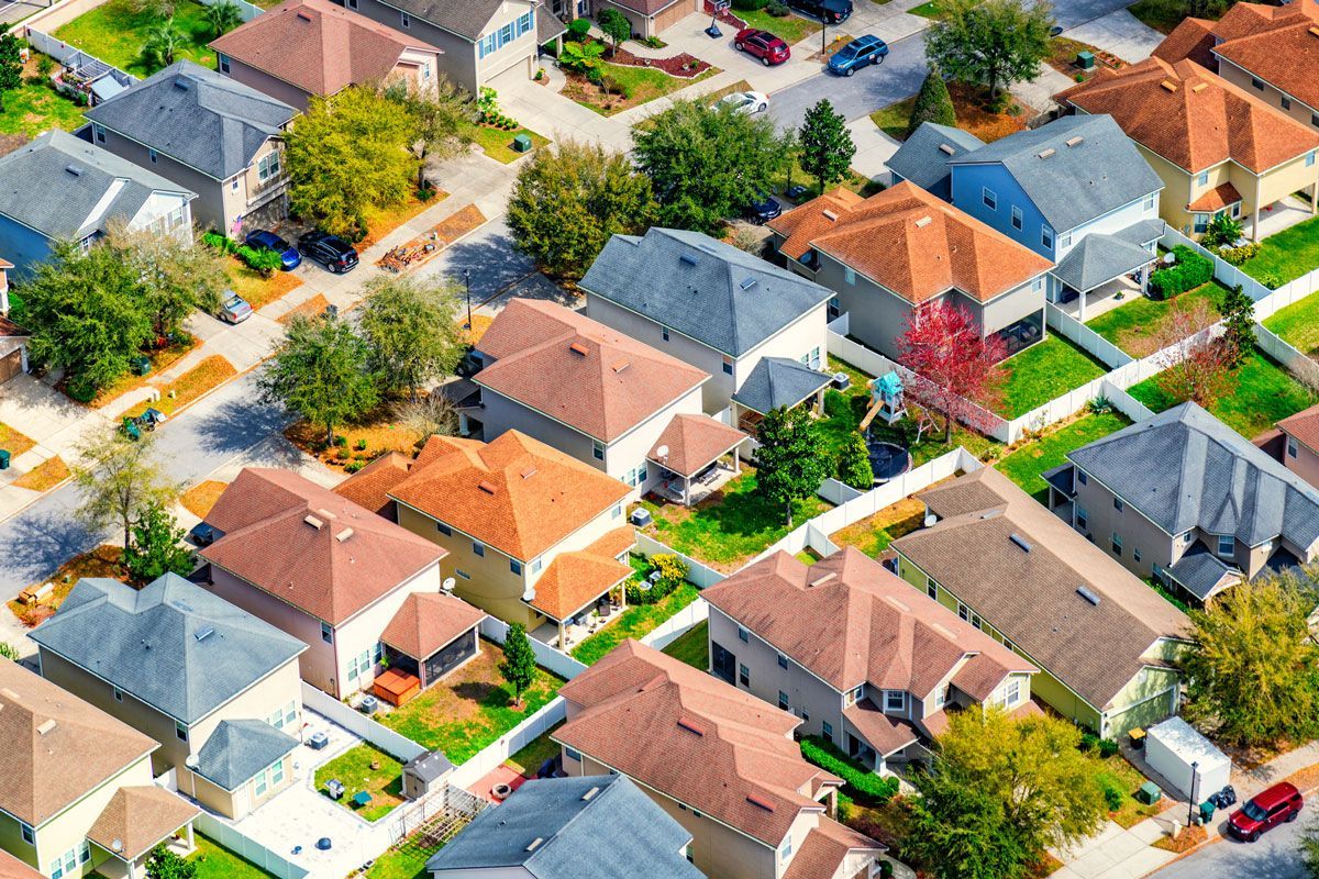 An aerial view of a residential neighborhood with lots of houses and trees.