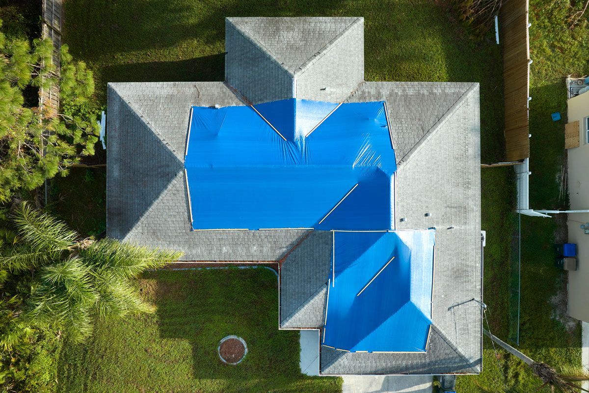 An aerial view of a house with a blue roof.