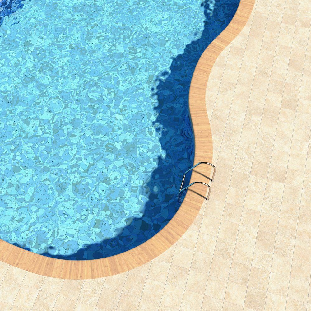 curved pool and paver deck