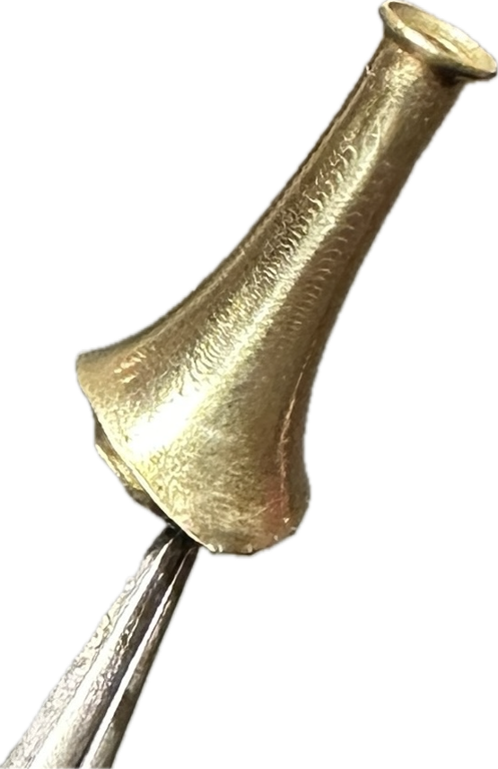 A close up of a brass object on a white background.