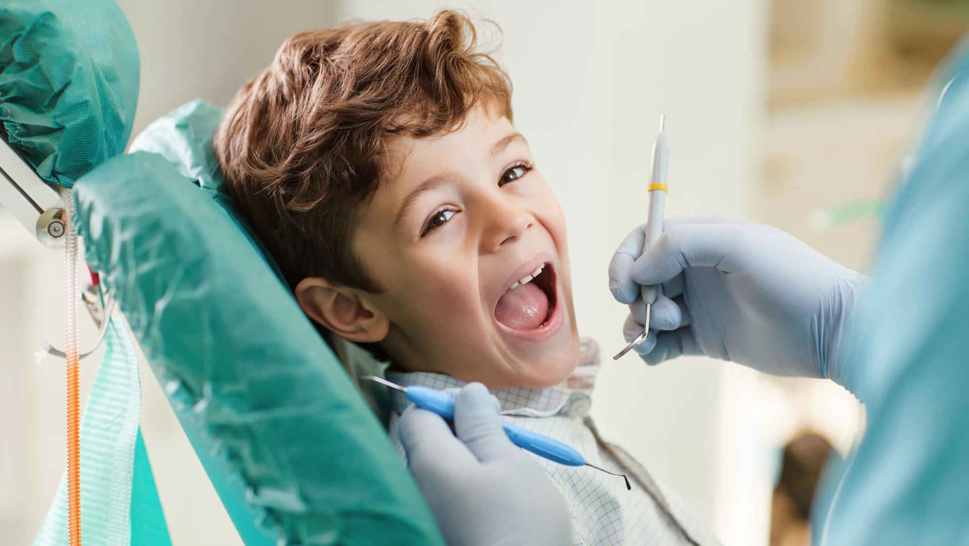 child with open mouth for dental checkup