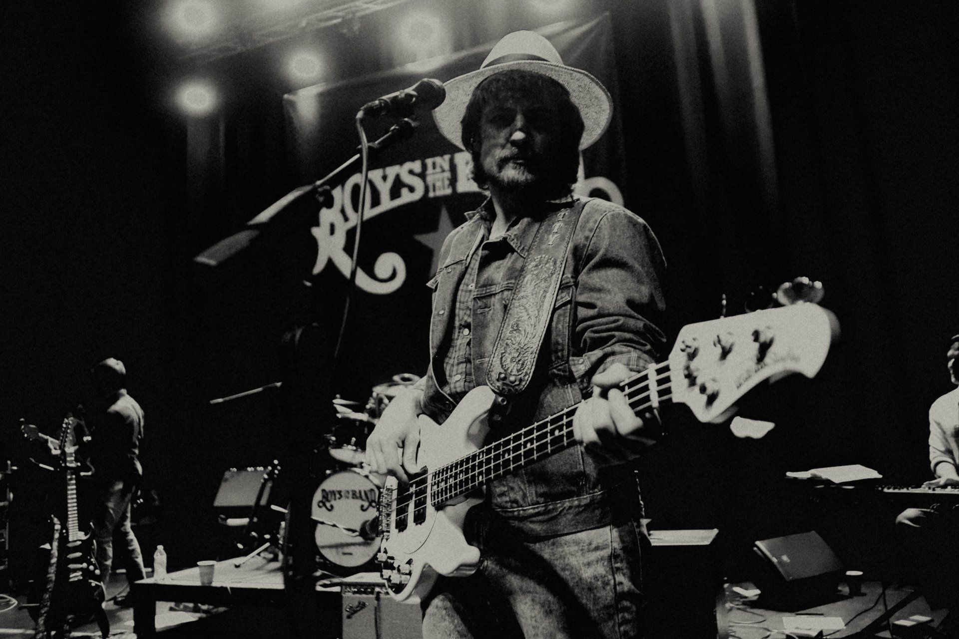 A black and white photo of a man playing a guitar