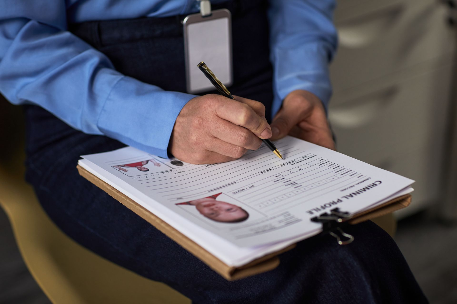 Person writes on a clipboard labeled 
