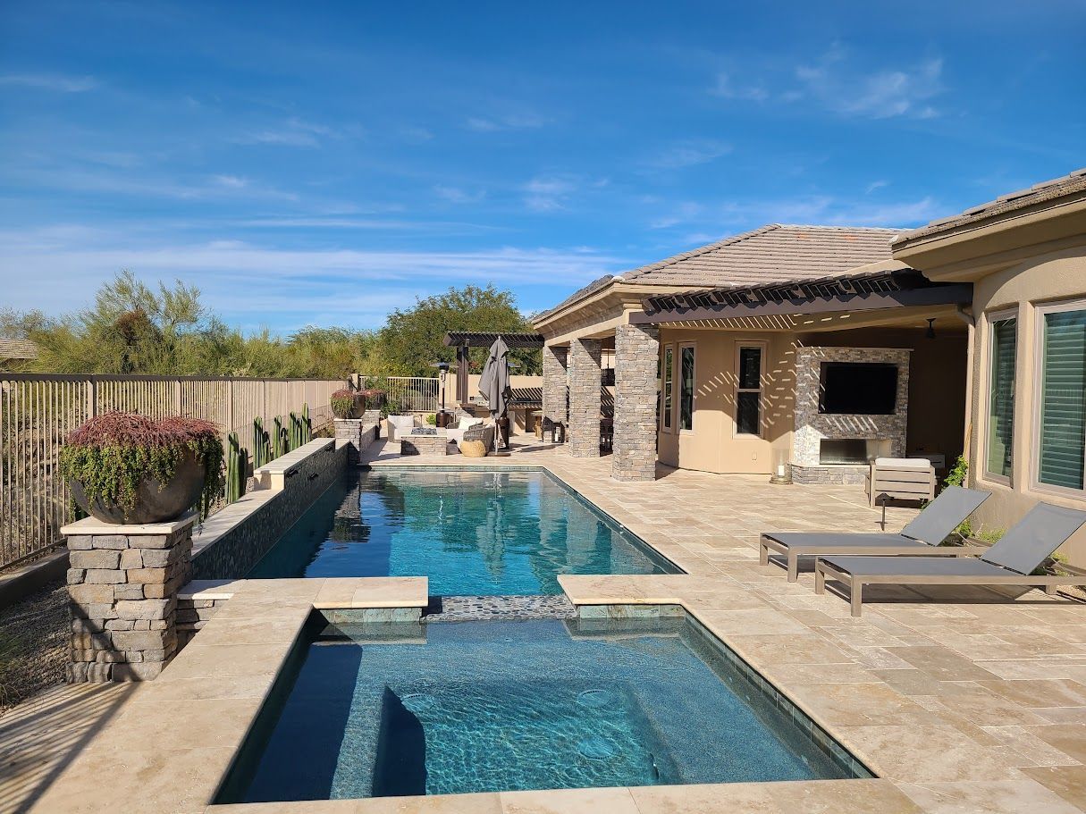 There is a large swimming pool in the backyard of a house.