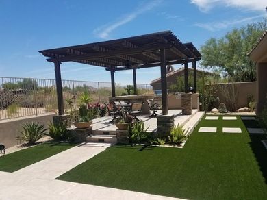 There is a pergola in the middle of the backyard.