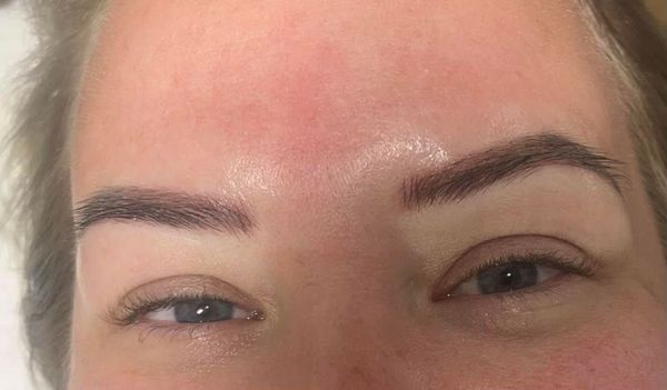 Close-up of a person's face with microbladed eyebrows.
