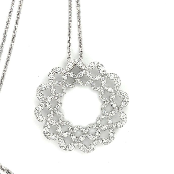 A necklace with a pendant that looks like a wreath of diamonds