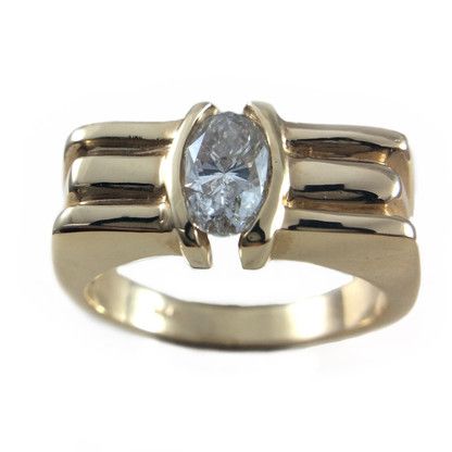 A gold ring with an oval diamond in the center