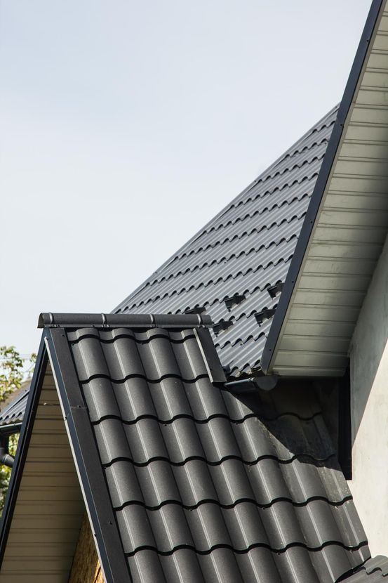 A close up of a black tile roof on a house.