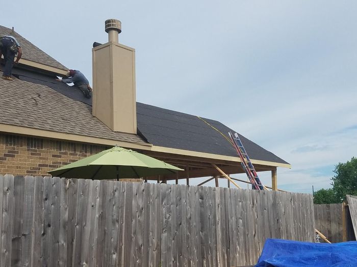 A close up of a black tile roof on a house.