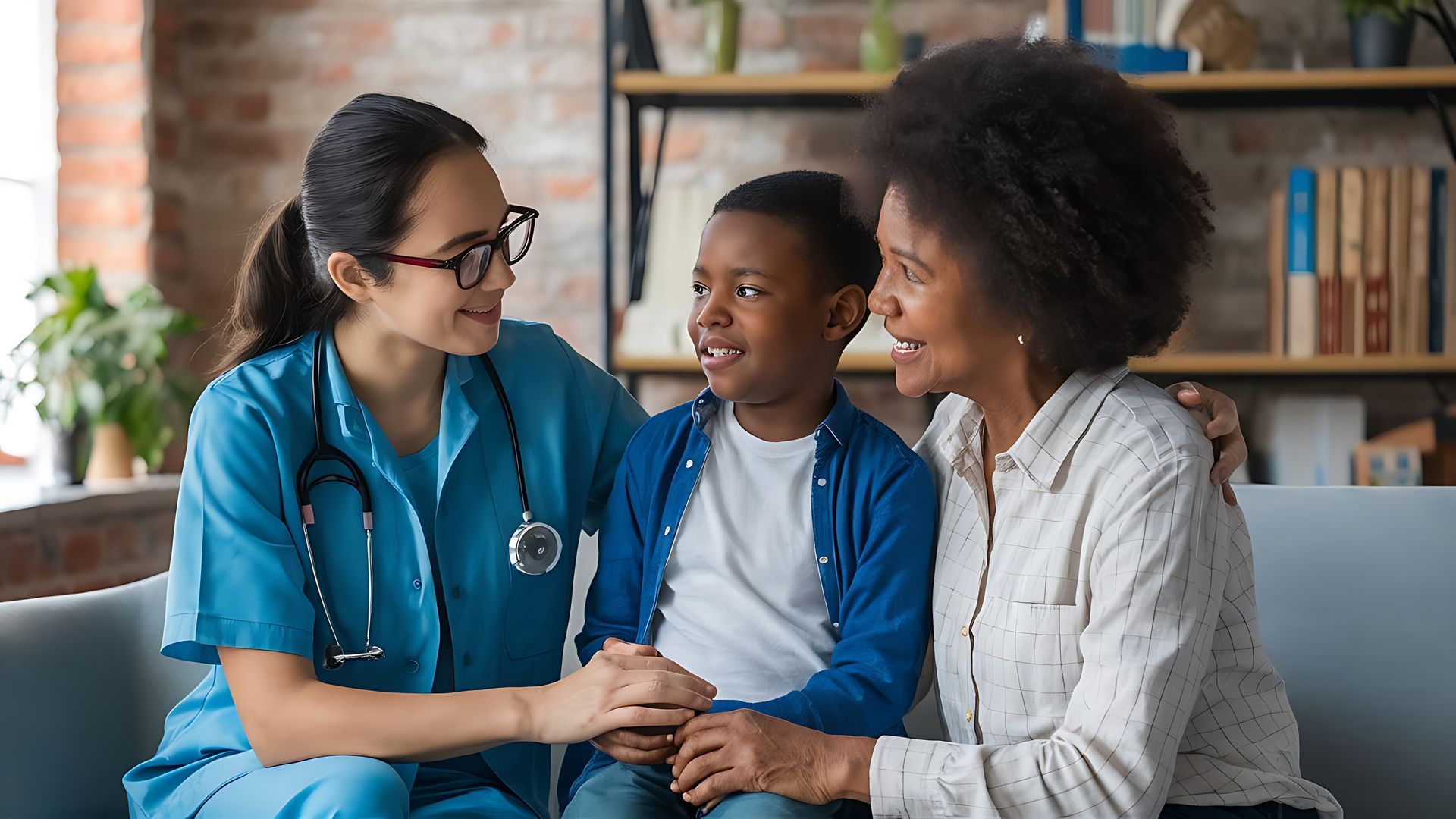A nurse is sitting on a couch with a woman and a child.