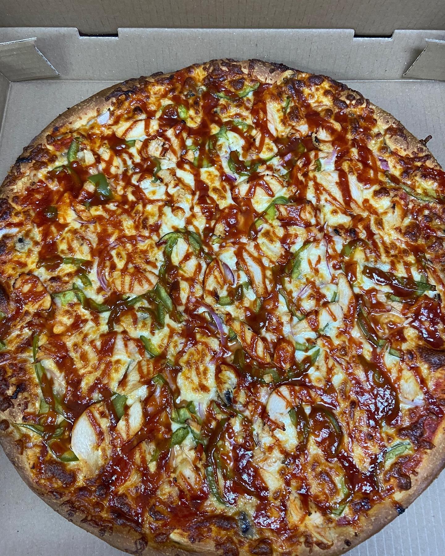 A pepperoni pizza with a slice taken out of it