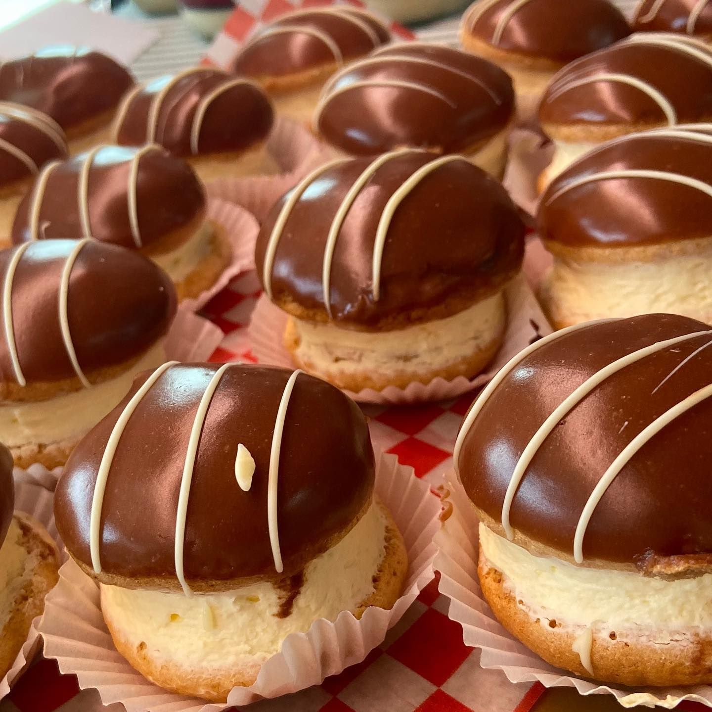 A close up of three baklava with pistachios on a white plate.