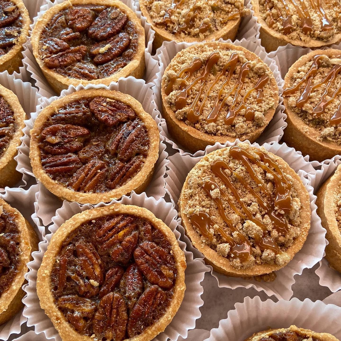 A bunch of pecan tarts are sitting on a table