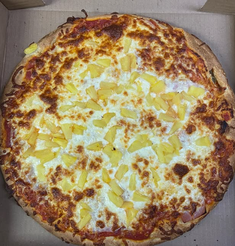 A pizza with a lot of toppings is in a box