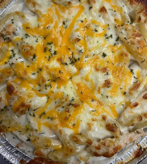 A close up of a plate of chicken parmesan on top of spaghetti.